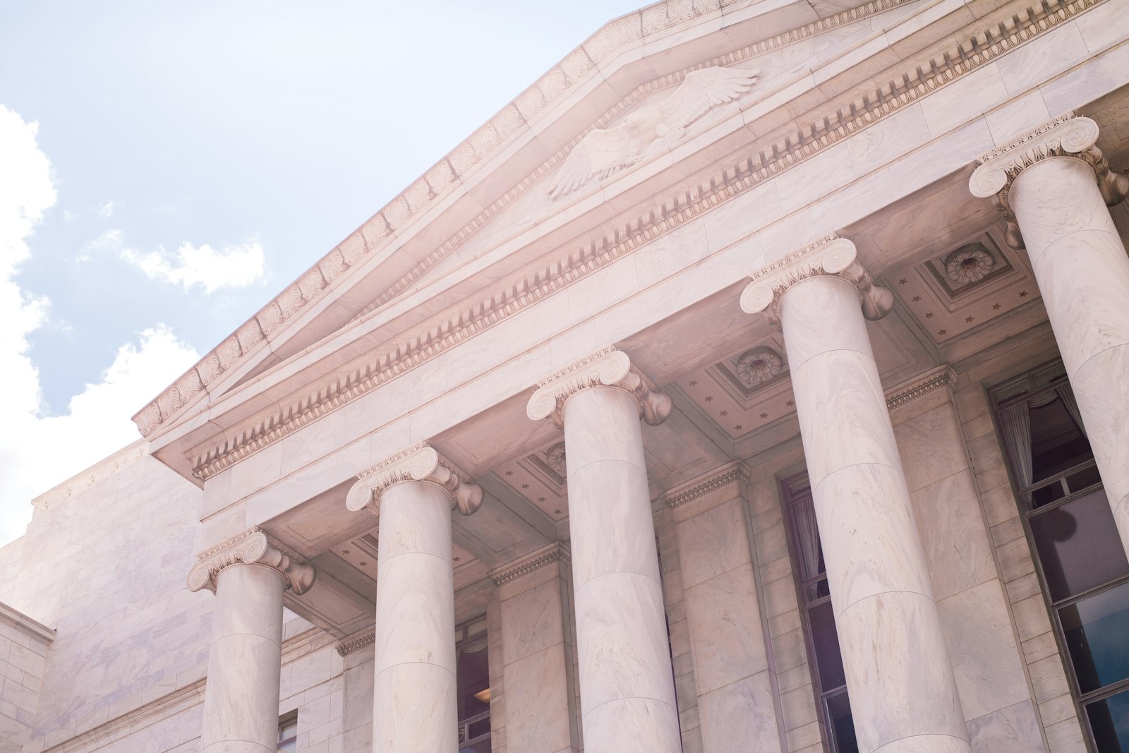 Neoclassical government building with stone columns; illustrative stock photograph, not a depiction of MILD staff or clients
